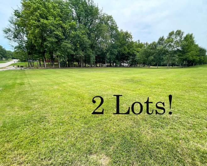 View of home's community with a lawn