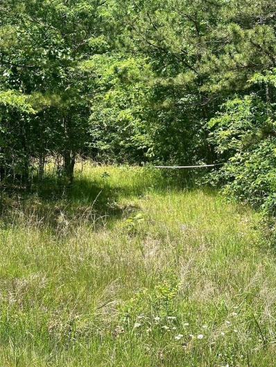 One of three entrances to property off paved road.