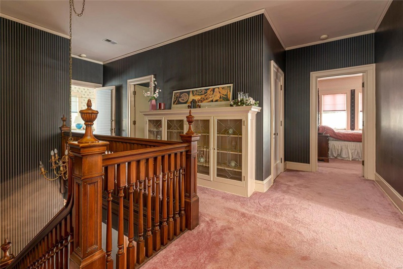 Hall featuring carpet floors and crown molding