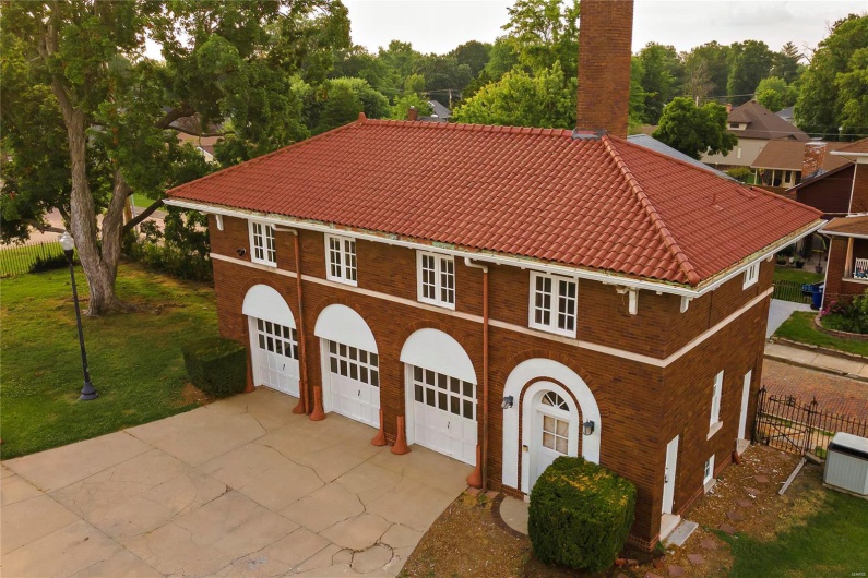 View of front of house featuring a garage and a front lawn
