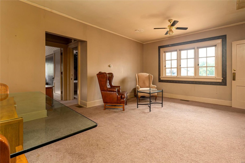 Sitting room with crown molding, carpet flooring, and ceiling fan