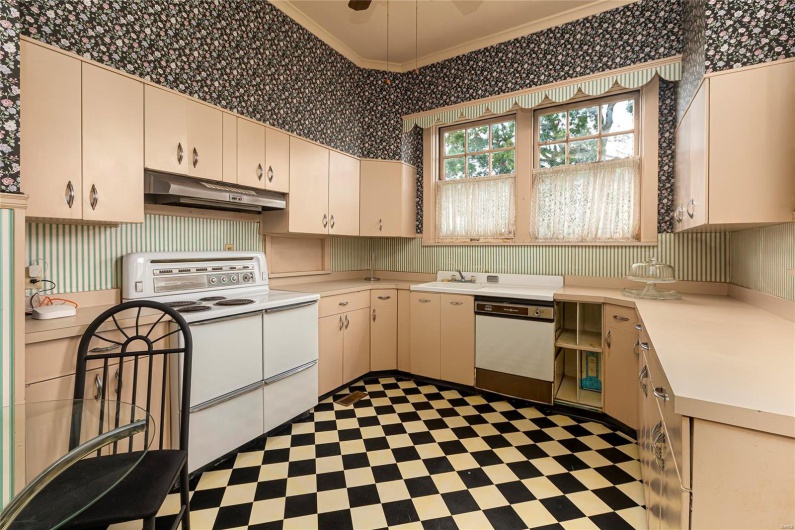 Kitchen featuring white appliances and crown molding