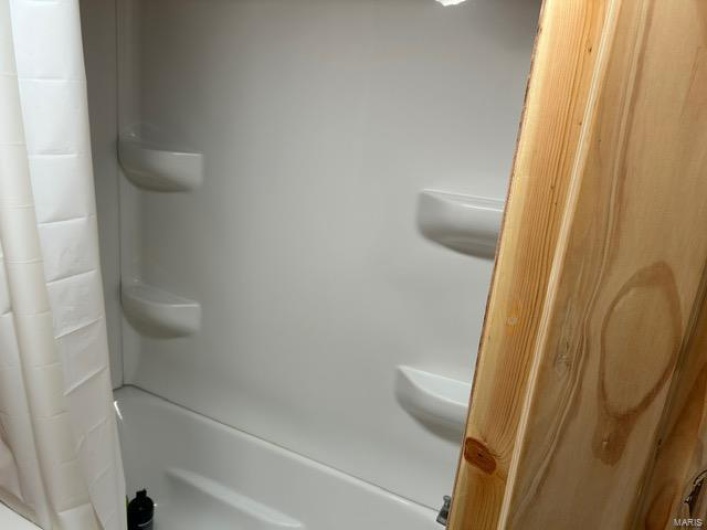 Full bath featuring a shower with shower curtain