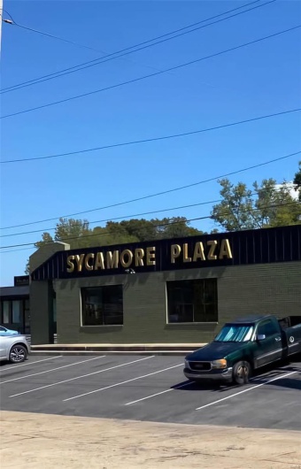 View of property with uncovered parking