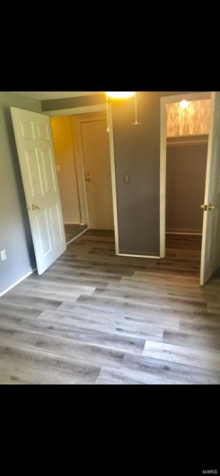 Unfurnished bedroom featuring a closet and light hardwood / wood-style floors