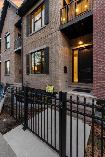 Exterior entry at dusk with a balcony
