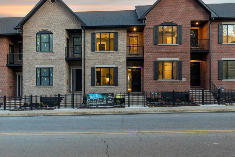 View of front of property with a balcony