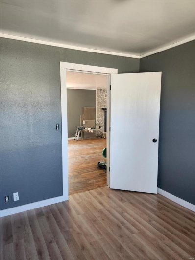 Spare room featuring wood finished floors and baseboards