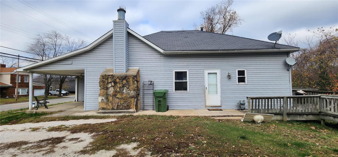 Rear view of property with a wooden deck
