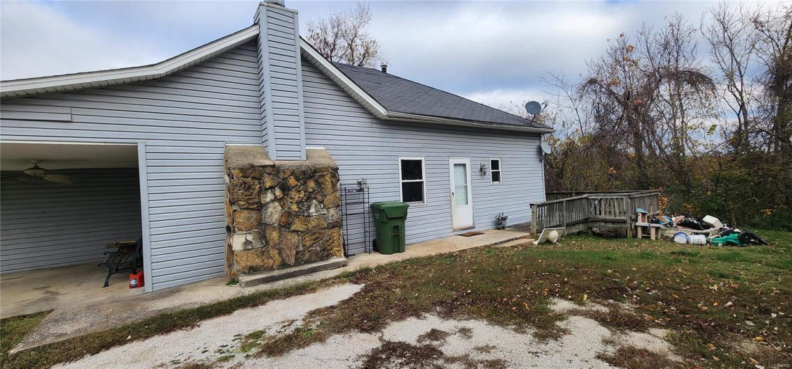Rear view of property with ceiling fan and a wooden deck