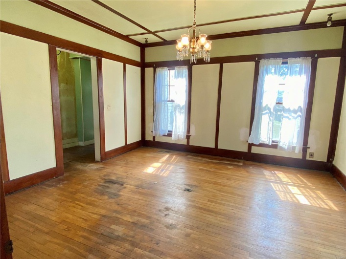 Unfurnished room with an inviting chandelier and hardwood / wood-style floors