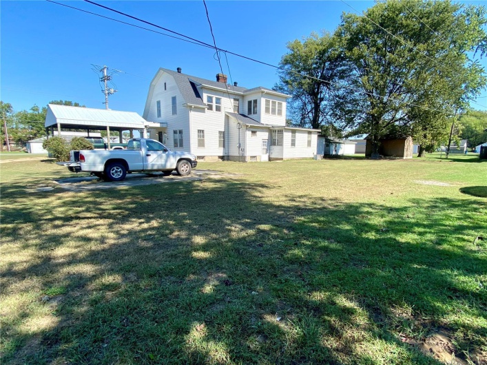 View of yard with a carport