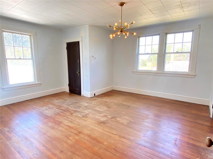 Empty room featuring an inviting chandelier and light hardwood / wood-style floors