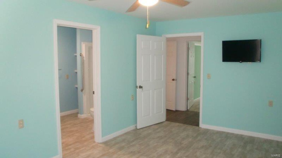 Unfurnished bedroom with light wood-type flooring and ceiling fan