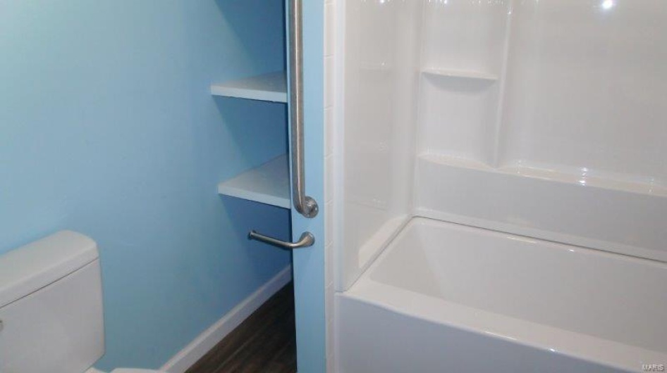 Bathroom with built in features and toilet