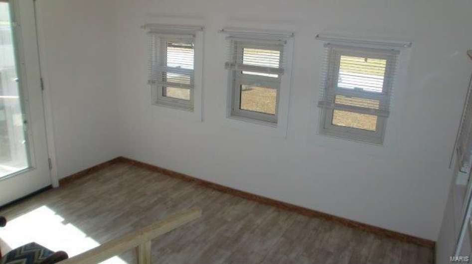 Spare room with dark hardwood / wood-style flooring