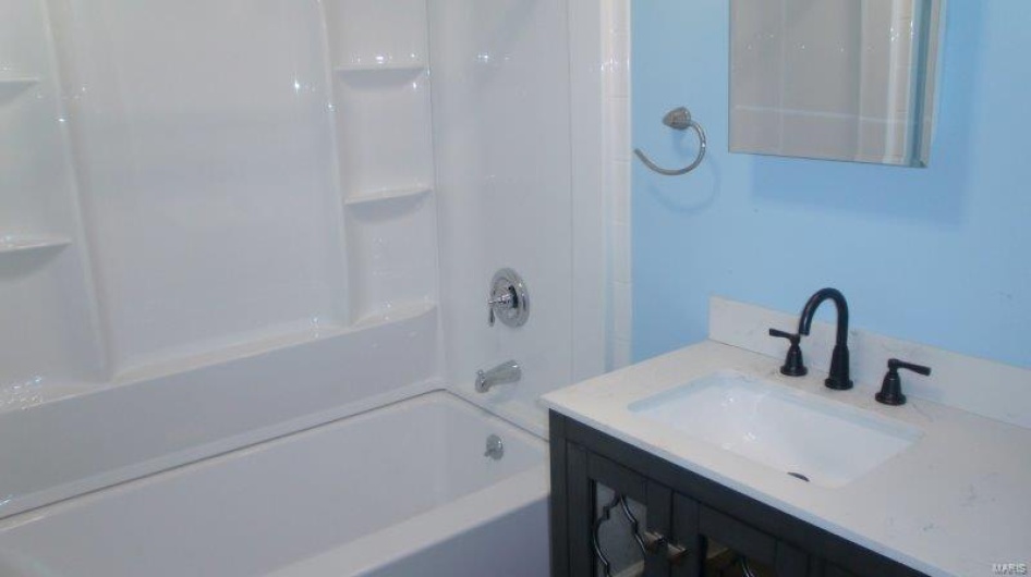 Bathroom featuring vanity and bathtub / shower combination
