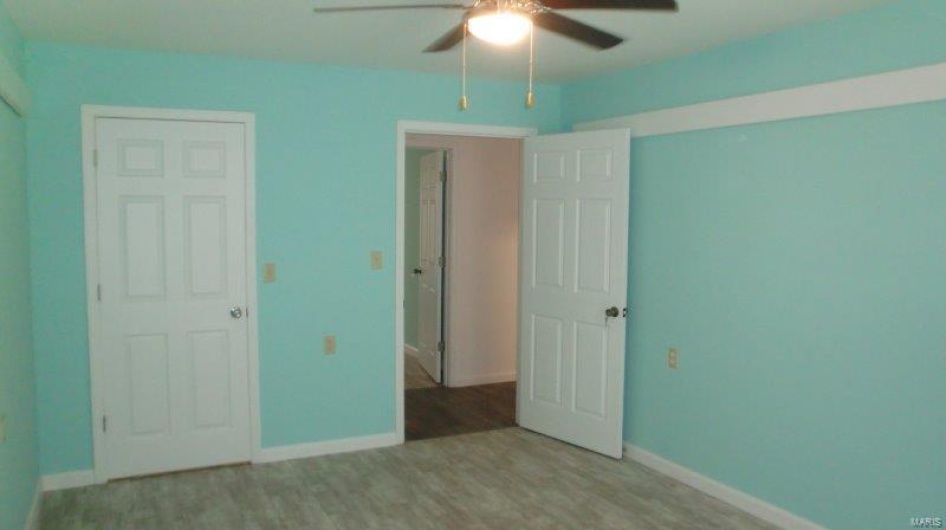 Unfurnished bedroom featuring light hardwood / wood-style floors and ceiling fan
