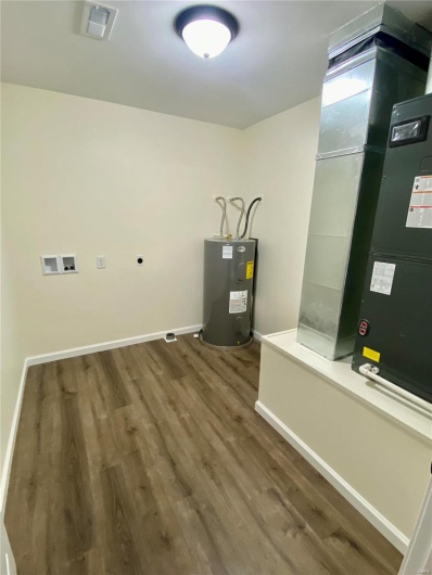 Utility room with water heater and heating unit