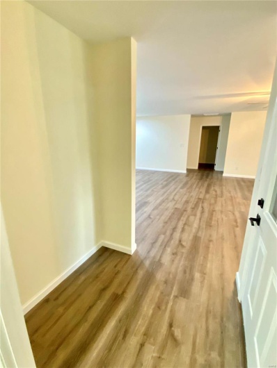 Empty room with hardwood / wood-style floors