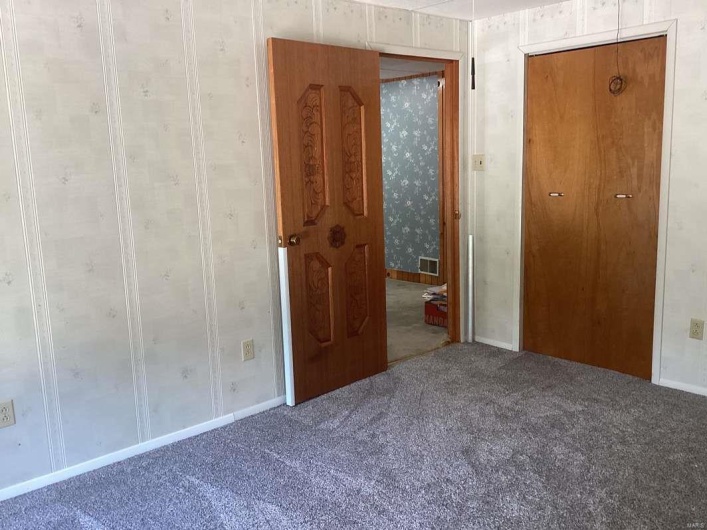 Unfurnished bedroom with carpet flooring