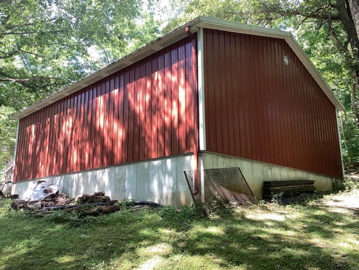 View of side of property featuring a yard