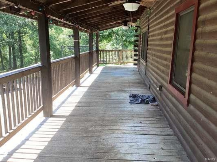 Wooden deck featuring ceiling fan
