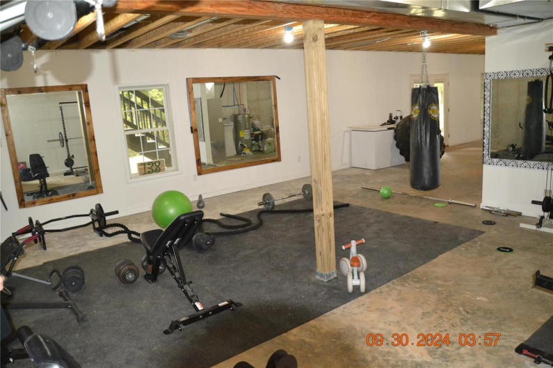 Exercise room featuring water heater