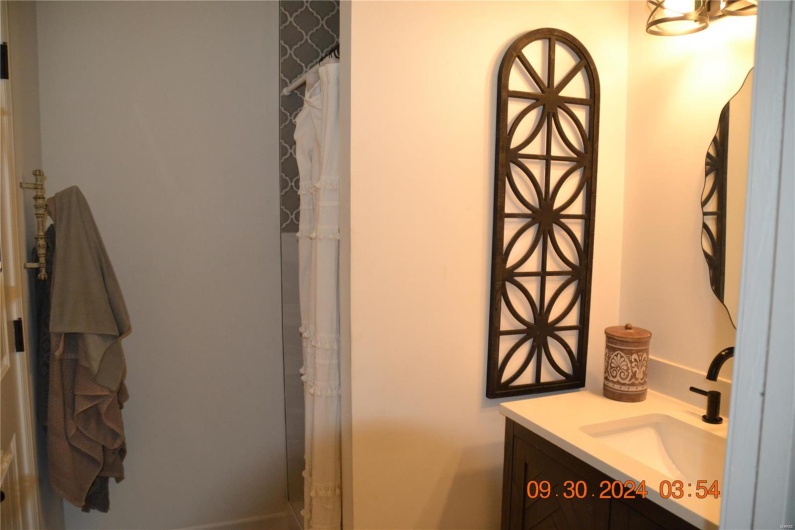 Bathroom featuring vanity and curtained shower
