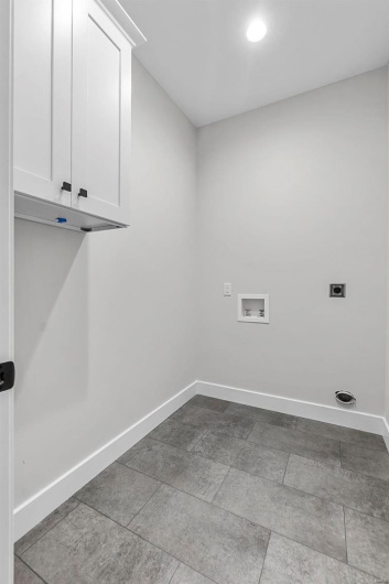 Laundry area with electric dryer hookup, cabinets, and hookup for a washing machine