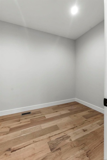 Empty room featuring hardwood / wood-style floors