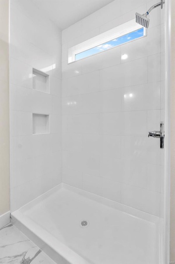 Bathroom featuring tiled shower