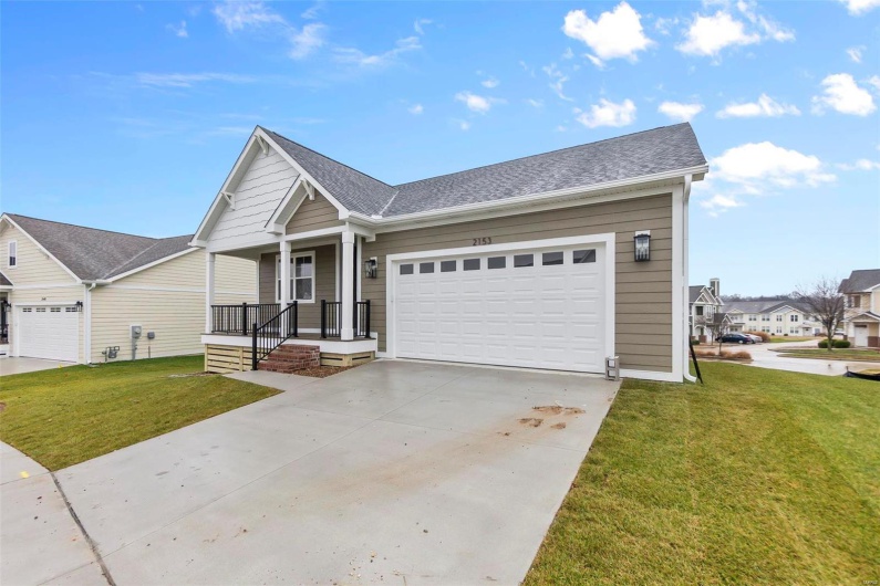 View of front facade with a garage and a front lawn