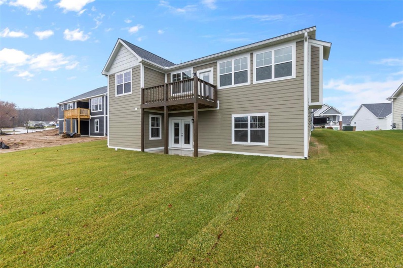 Back of property with french doors, a yard, and a deck