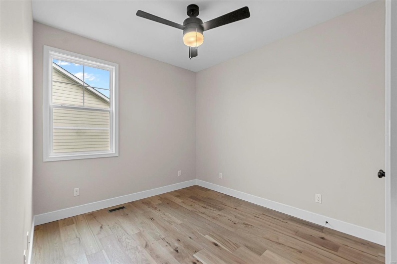 Empty room with light hardwood / wood-style floors and ceiling fan