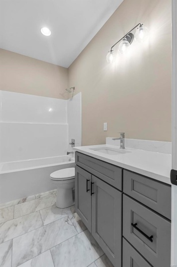 Full bathroom featuring vanity,  shower combination, and toilet