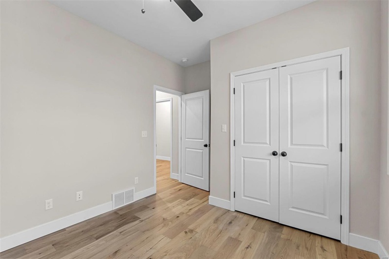 Unfurnished bedroom featuring a closet, ceiling fan, and light hardwood / wood-style floors