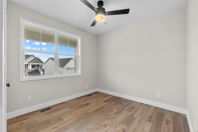 Spare room with ceiling fan and light hardwood / wood-style floors