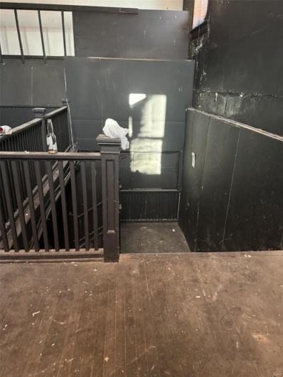 Basement with dark wood-type flooring