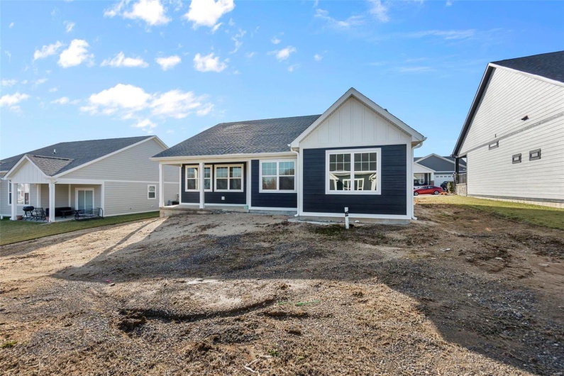 Rear view of property with board and batten siding