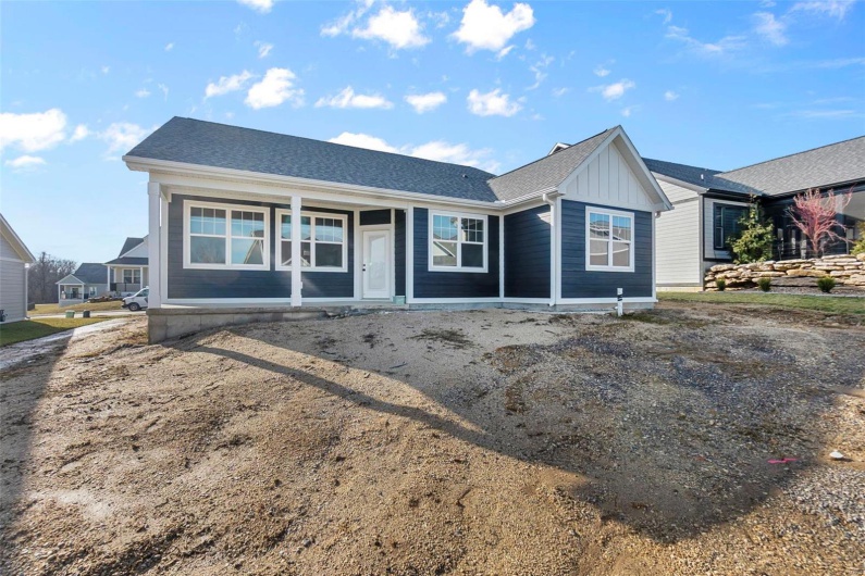 Ranch-style house featuring board and batten siding and roof with shingles