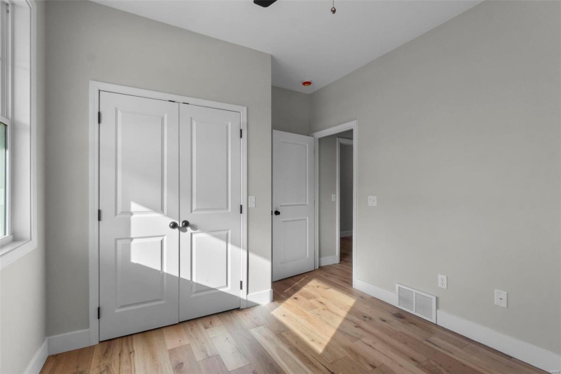 Unfurnished bedroom featuring baseboards, visible vents, a ceiling fan, light wood-type flooring, and a closet