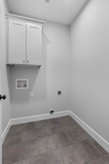 Laundry area with baseboards, washer hookup, cabinet space, and hookup for an electric dryer