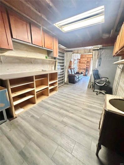 Basement with light hardwood / wood-style floors