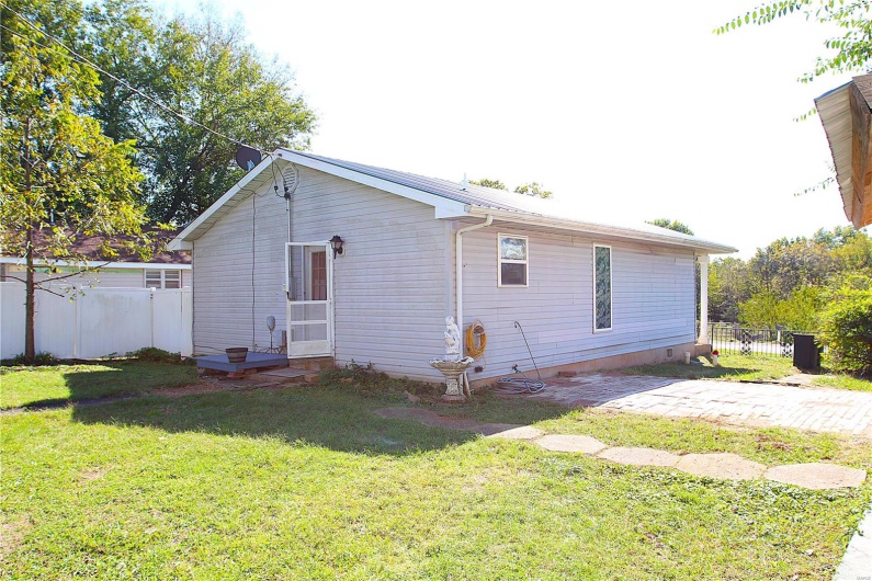 Rear view of property featuring a lawn