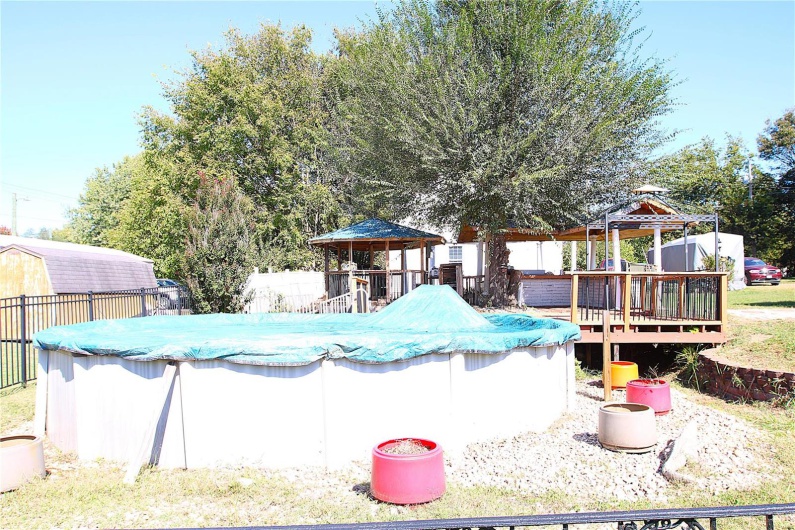 View of pool featuring a gazebo and a deck
