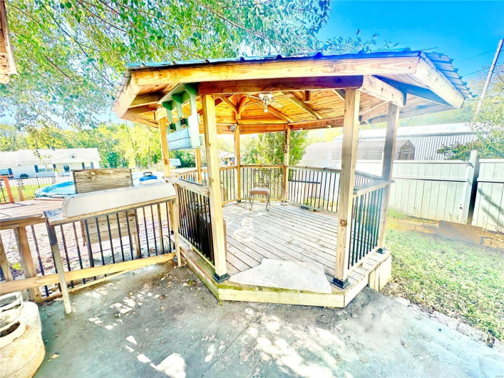 Wooden deck with a gazebo and ceiling fan