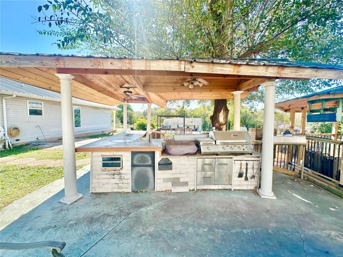 View of patio with exterior kitchen, a gazebo, ceiling fan, and grilling area