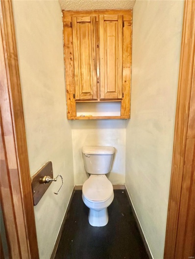 Bathroom featuring toilet and a textured ceiling