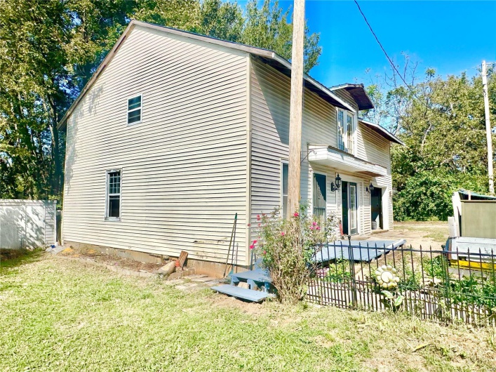View of property exterior with a yard